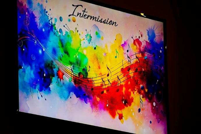 Colorful abstract background with musical notes and intermission text.